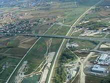 Aerial view of a large, mostly dry and grassy canal