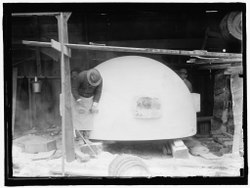 Carving of the top of the world globe. Notice the protruding anchors left on the sides of the block to lift it into place. Columbus Memorial Construction a.tif