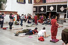 Buddhists performing prostrations in front of Jokhang Monastery. IMG 1016 Lhasa Barkhor.jpg