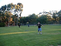 Youth playing a game of cricket on Langman's oval Langman reserve.JPG