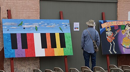 A man looking at a painting at the 23rd Annual Brownsville Latin Jazz Festival