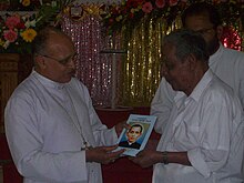 Mar Jacob Manathodath, bishop of Palakkad diocese, releasing the biography of Venerable Payyappilly Mar Varghese Kathanar during his 82nd death anniversary by handing over a copy of it to his great-nephew Mathai Payyappilly Palakkappilly Mar Jacob Manathodath and Mathai Payyappilly Palakkappilly.jpg