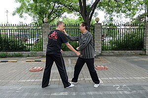 Master Di Guoyong of Beijing demonstrating a zuanquan application as part of a partner practice form (dui lian). Master Di Guoyong of Beijing demonstrating a Zuan Quan application as part of a partner practice form, 2014.jpg