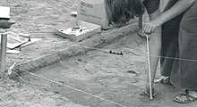 Measuring elevation with a line level and measuring tape. Measuring elevation with a line level. Historical archaeology at the old Champoeg townsite, Champoeg, Oregon (USA) 1973 (2149089991) (cropped).jpg