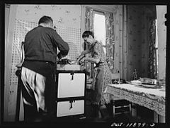 Mr. and Mrs. Earle Landis turn over their Thanksgiving turkey