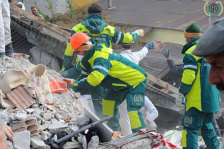 Rescue workers looking for survivors under building rubble after the 2011 Van earthquake