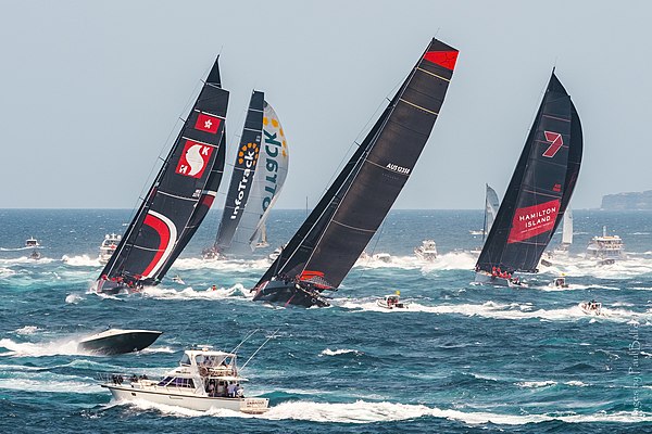 InfoTrack leads the fleet through Sydney Heads and south to Hobart in ideal, if smoky conditions at the start of the 75th Sydney to Hobart Yacht Race 