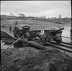 Quad tractor towing a 25-pdr and limber over a pontoon bridge during exercises in Northern Ireland The British Army in the United Kingdom 1939-45 H15716.jpg