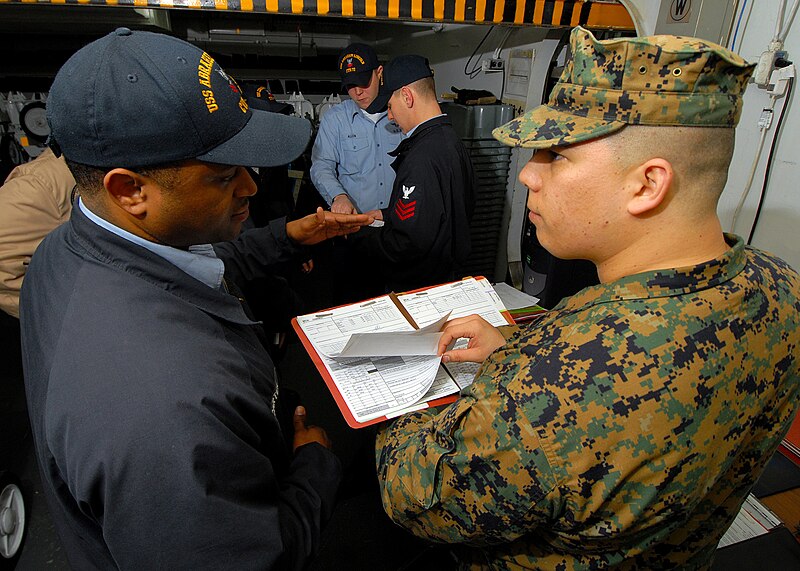 File:US Navy 070424-N-7981E-069 Marine Sgt. Jesus R. Rivera, a quality assurance representative (QAR) from Fleet Readiness Center (FRC) Northwest, reviews maintenance history records.jpg