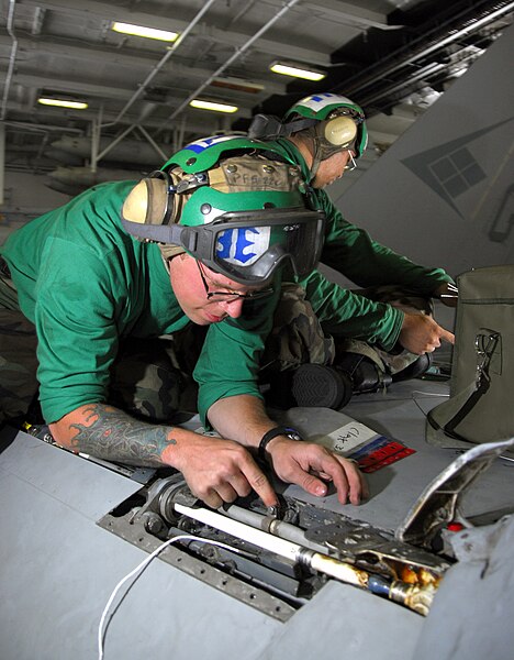 File:US Navy 090211-N-6597H-065 Aviation Electrician's Mate 3rd Class Jon Miller, from Waterford, Mich., performs scheduled electrical maintenance on an F-A-18C Hornet from the.jpg