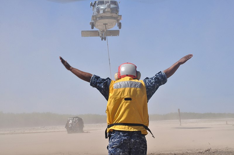 File:US Navy 100130-N-2878C-001 Sailor directs helicopter in Haiti.jpg