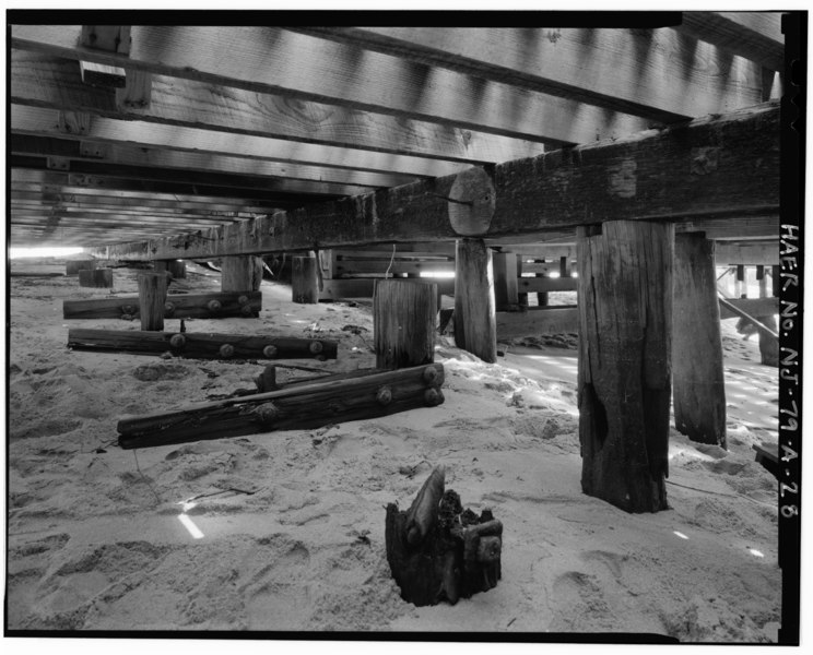 File:View northeast, wharf A, portion AA, details showing earlier piers and braces sloping toward water, reused charred plates for existing decking - U.S. Coast Guard Sandy Hook HAER NJ,13-HIGH,1A-28.tif