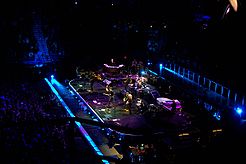 Deep blue stage lighting matched the album cover's look and feel during a Working on a Dream Tour performance of the title song; the band looks on as Clarence Clemons does the whistling break. Hartford Civic Center, April 24, 2009. WorkingOnADreamHartford042409.jpg