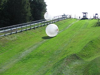 Zorbing Sport of rolling downhill inside a ball