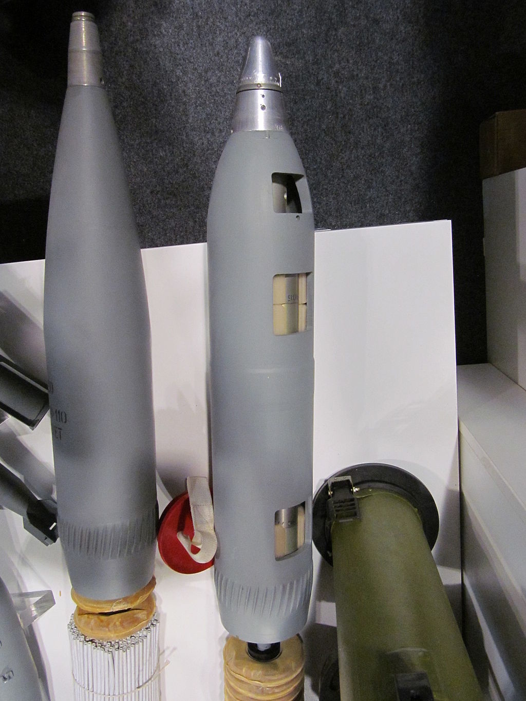 1024px-120_mm_3VOF110_high_explosive_round_and_3VO32_cargo_bomb.JPG