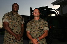 Sgt. Lorenzo L. Edwards (left) and Staff Sgt. Matthew J. Davis, both from 3rd Battalion, 23rd Marine Regiment, volunteered to stay behind at the 3/23 emergency operations center during Hurricane Katrina. 3/23 Marines supported area clean ups, relief convoys and assisted the 24th Marine Expeditionary Unit Command Element (2005) 3 23 katrina.jpg