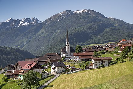 Panorama of Wenns, showing the Church of Johannes Evangelist, and snow-capped mountains