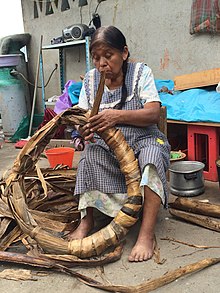 Craftswoman making banana leaf bun in Tavehua, Oaxaca.