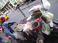 A vendor barbecuing along a Bangkok, Thailand street Bangkok street food vendor.jpg