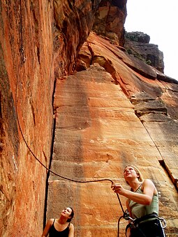 A belayer is belaying behind a lead climber. Belaying.jpg