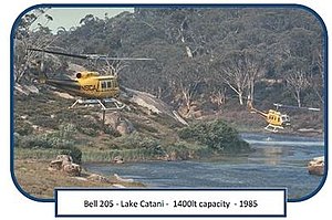 NSCA Bell 205's fitted with firebombing belly tanks hovering over Lake Catani, Mt Buffalo National Park - 1985. Source: Brian Rees. FCRPA* collection. Bell 205 - 1985.jpg