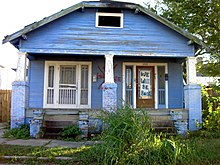 Blue house on N. Robertson St., Upper 9th Ward. The door reads, "We will be back." Blue House, N. Robertson St. 4500 Blk, New Orleans LA.JPG