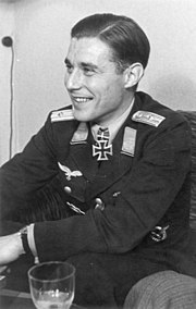 Prince Zur Lippe-Weißenfeld is casually sitting and smiling. The Knight's Cross of the Iron Cross, German Cross in Gold and Pilots Badge can be seen on his uniform.