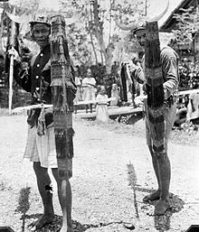 Indigenous people performing the Tjakalélé dance with spears and shields in Bora te Biromaru kampong