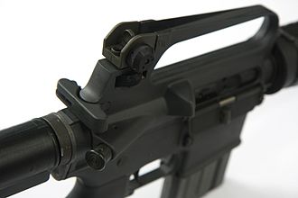 Colt/Armalite - T-shaped charging handle below and behind the rear sight, with the forward assist below and to the right Colt AR-15 Sporter Lightweight rifle - upper handle (8378298701).jpg