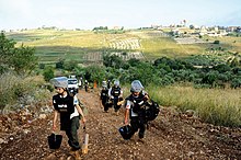 Landmines are also a hazard that cause much loss of life and injury. Female de-miners in Lebanon set off to clear landmines. Disaster Risk Reduction, Lebanon (10692796606).jpg