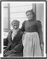 Elderly African American couple posed outside of building, near Hampton Institute, Hampton, Va. 97510140.jpg