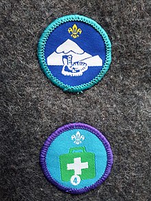 A hill-walker Explorer Scout activity badge (top) and an Emergency Aid stage 4 staged activity badge (below). Explorer Scout badge designs.jpg