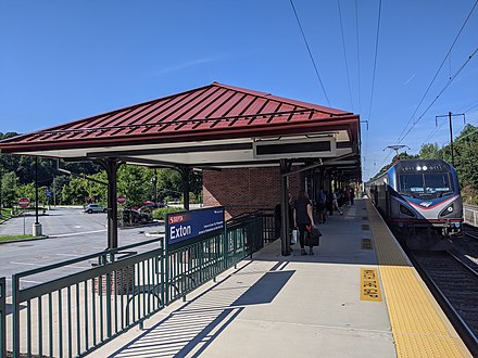 An eastbound Keystone Service train arriving at the rebuilt Exton station in 2021