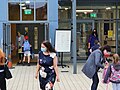 A principal and vice-principal greet returning students on the first day of school.