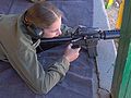 A Israleli 8th grade girl is aming with an M16A2