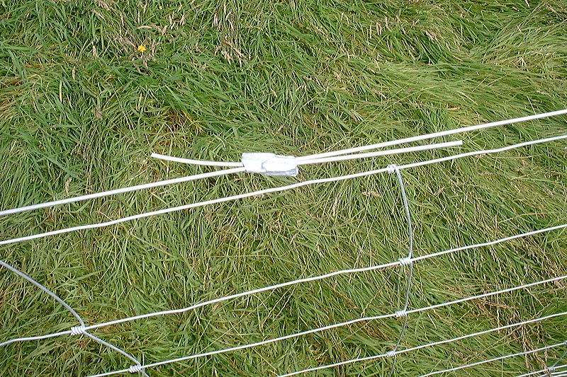File:Gripple on a fence wire.jpg