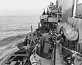 The gun crews of a Navy cruiser covering American landing on the island of Mindoro, Dec. 15, 1944, scan the skies in an effort to identify a plane overhead. Two 5 (127mm) guns are ready while inboard 20mm anti-aircraft crews are ready to act.