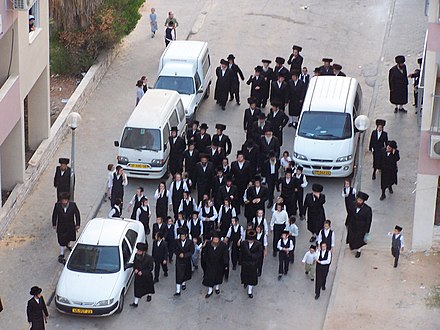 Hasidim walk to the synagogue, Rehovot, Israel.