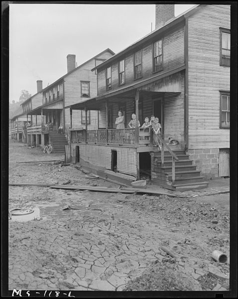 File:Home and family of Monzel Cox in company housing project. In foreground of picture is caked mud left by flood of... - NARA - 540284.jpg