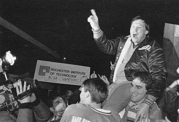 RIT players carry coach Bruce Delventhal after winning the 1985 national championship.