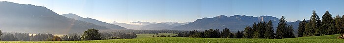 Blick von Gaißach-Dorf nach Süden in den Isarwinkel. Im Hintergrund: Karwendelgebirge (Mitte), und Benediktenwand (ganz rechts)