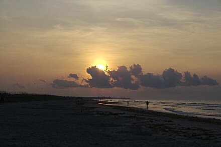 A red sun rises over the Isle of Palms