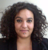 Portrait photo of a woman with curly brown hair, 