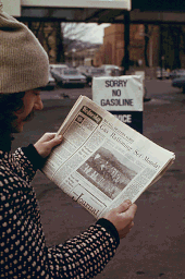 A man at a service station reads about the gasoline rationing system in an afternoon newspaper; a sign in the background states that no gasoline is available. 1974 No gas 1974.gif