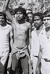 Noor Hossain, a pro-democracy demonstrator, "sbairaacaar niipaat yaak//" The words, in bright white paint written on the bare chest on 10 November 1987 protest for democracy in Dhaka, photographed by Dinu Alam just before he was shot dead by President Ershad's security forces Noor Hossain at 10 November 1987 protest for democracy in Dhaka (01).jpg