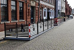 Outdoor seating spaces known as 'parklets' along Princes Dock Street in Kingston upon Hull. Installed by Hull City Council in August, opinion is divided on whether they provide decent outdoor seating space or take away parking from within the City Centre.