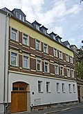 Apartment building in closed development, with shop