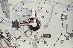 Ed Gibson floats out of the Multiple Docking Adapter connecting the station to the crew's Command Module.