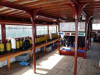 The deck of a dive boat for about 35 divers, with equipment and whiteboard for dive planning