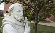 Curley is managed and staffed by the Order of Friars Minor, Conventual (Our Lady of the Angels Province) St francis statue archbishop curley high school baltimore.jpg